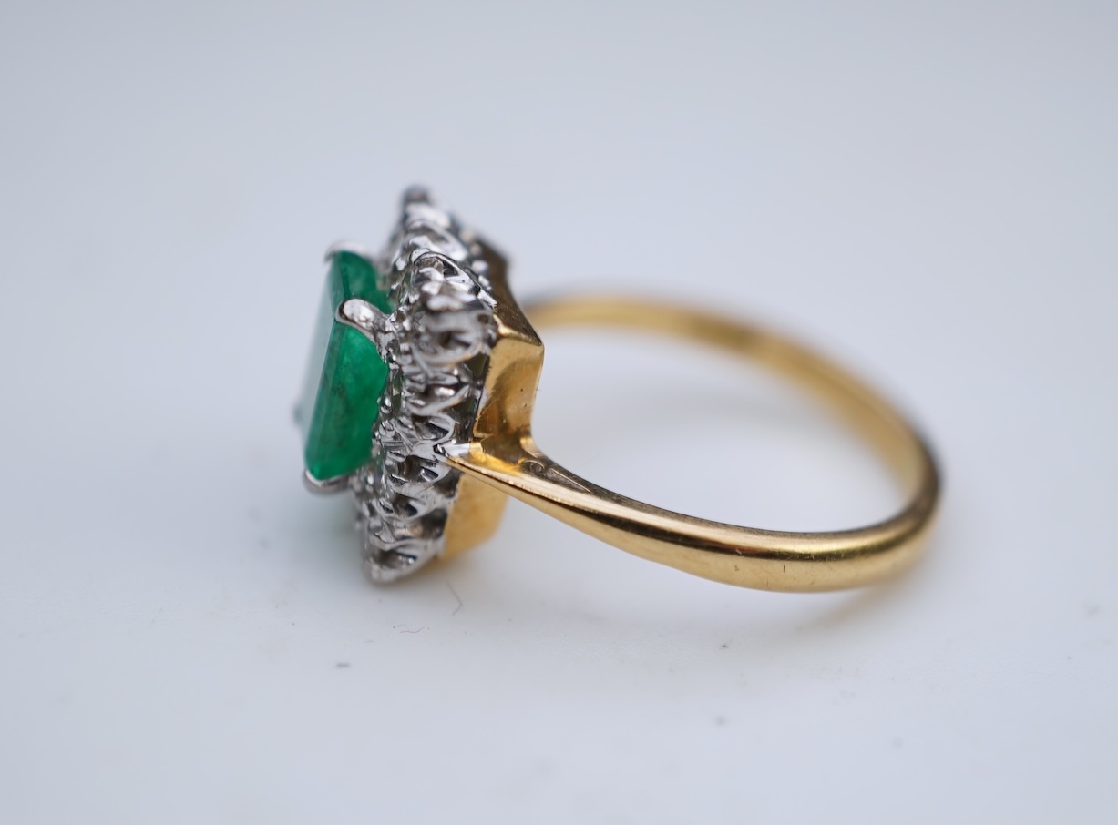 An emerald and diamond ring